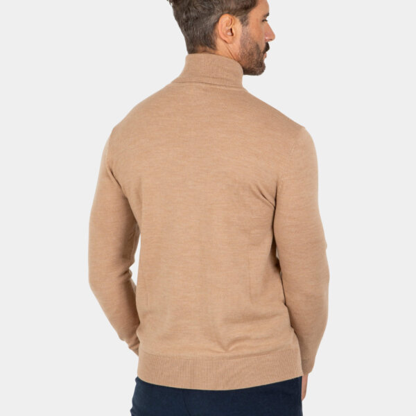 merino-wool-turtleneck-khaki-back Model wearing a khaki Merino wool turtleneck sweater, back view.