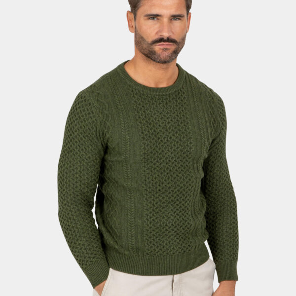 Model wearing a green cotton crew cable-knit sweater, front view.