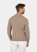 Model wearing a brown cotton cable-knit quarter zip sweater, back view.