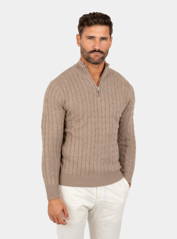 Model wearing a brown cotton cable-knit quarter zip sweater, front view.