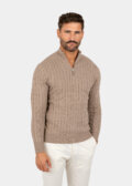 Model wearing a brown cotton cable-knit quarter zip sweater, front view.