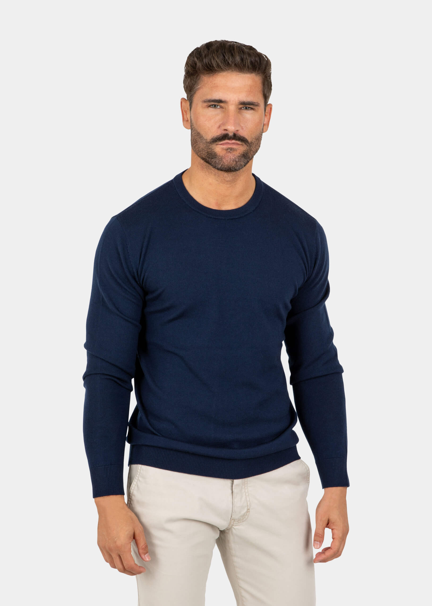 Model wearing a navy Merino wool crew neck sweater, front view.