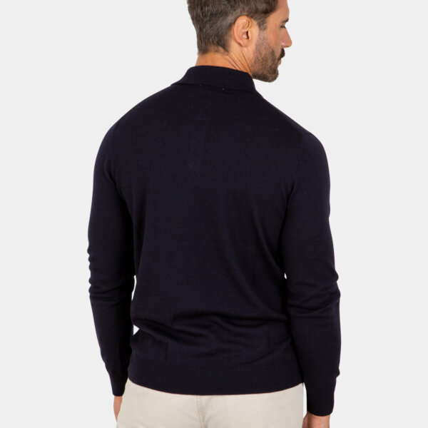 merino-wool-polo-navy-back Model wearing a navy Merino wool polo sweater, back view.