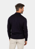 Model wearing a navy Merino wool polo sweater, back view.