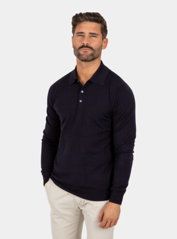 Model wearing a navy Merino wool polo sweater, front view.