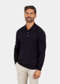 Model wearing a navy Merino wool polo sweater, front view.
