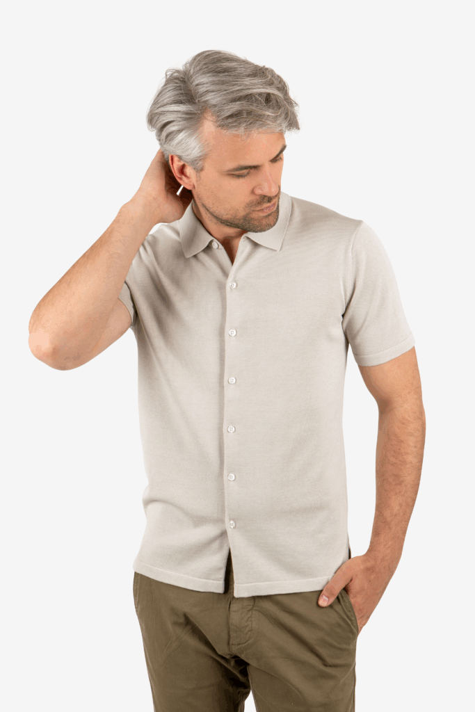 Front view of men’s khaki knit button-up shirt with spread collar, worn by model
