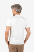 Back view of man wearing white knit button shirt with short sleeves and spread collar.