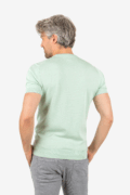 Back view of men’s green knit tee with tailored shape, worn by model
