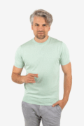 Front view of men’s green knit tee with crew neck, worn by model