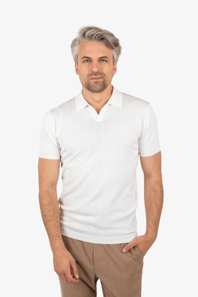 Front view of men’s open collar knit polo in white, worn by model