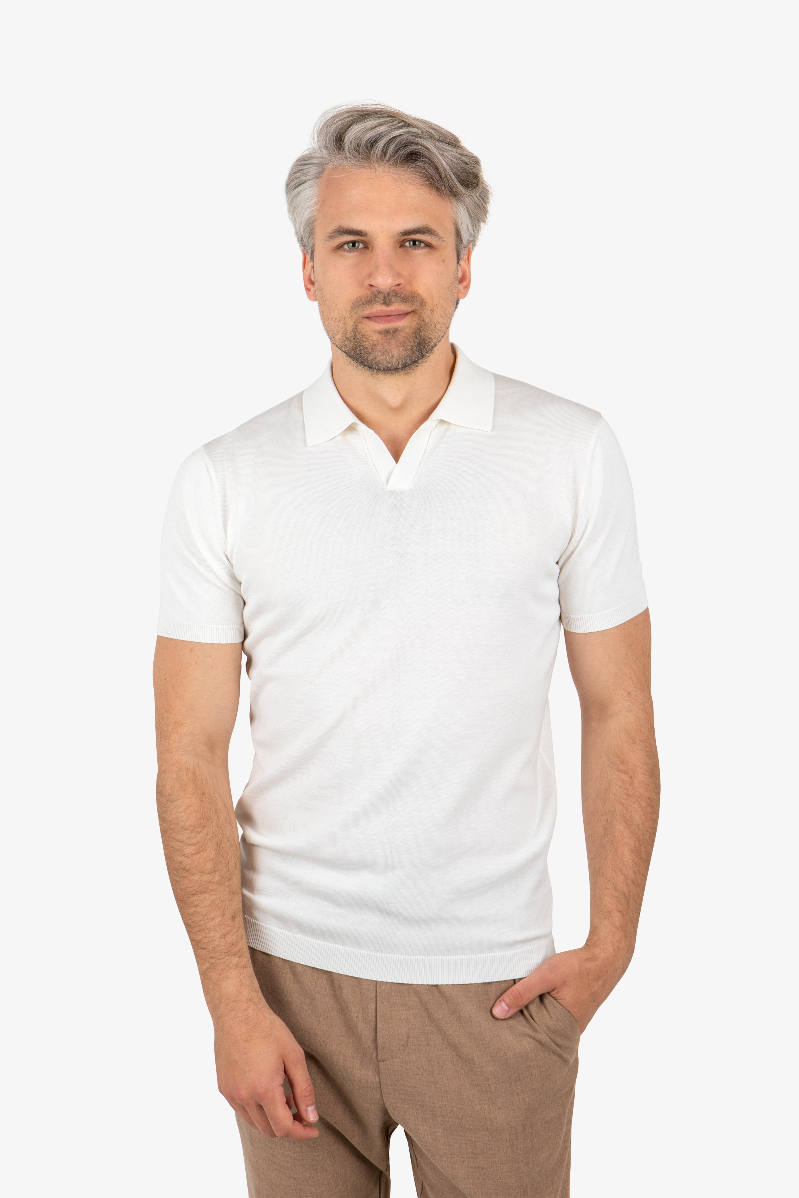 Front view of men’s open collar knit polo in white, worn by model