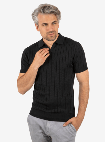 Front view of men’s ribbed knit polo in black, worn by model